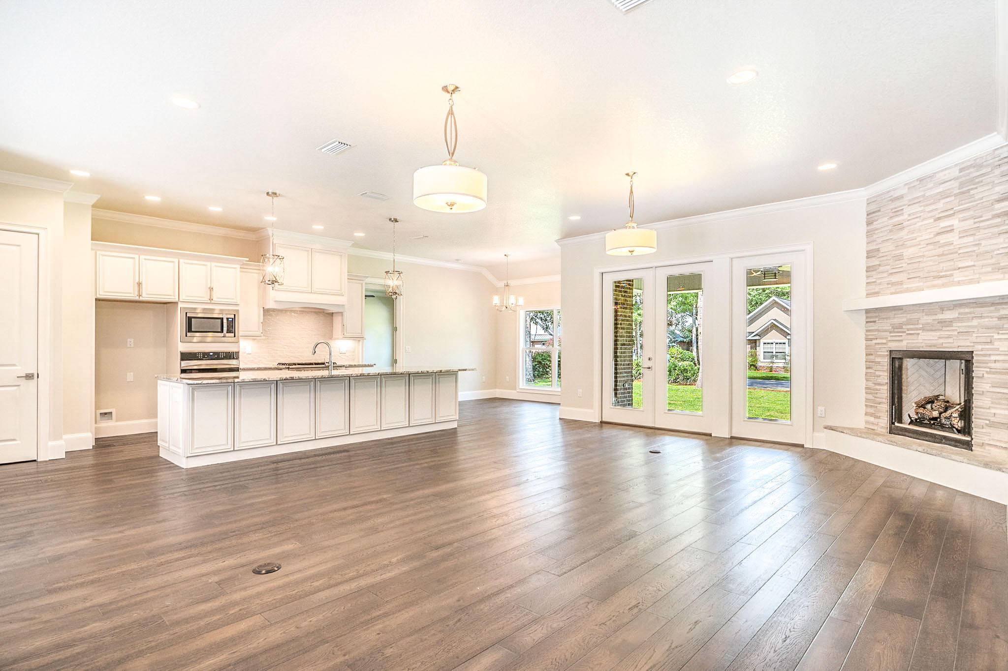 4809 Grove Street Crestview, FL 32539 - Photo 2 of 28 an open kitchen with white cabinets and outdoor space