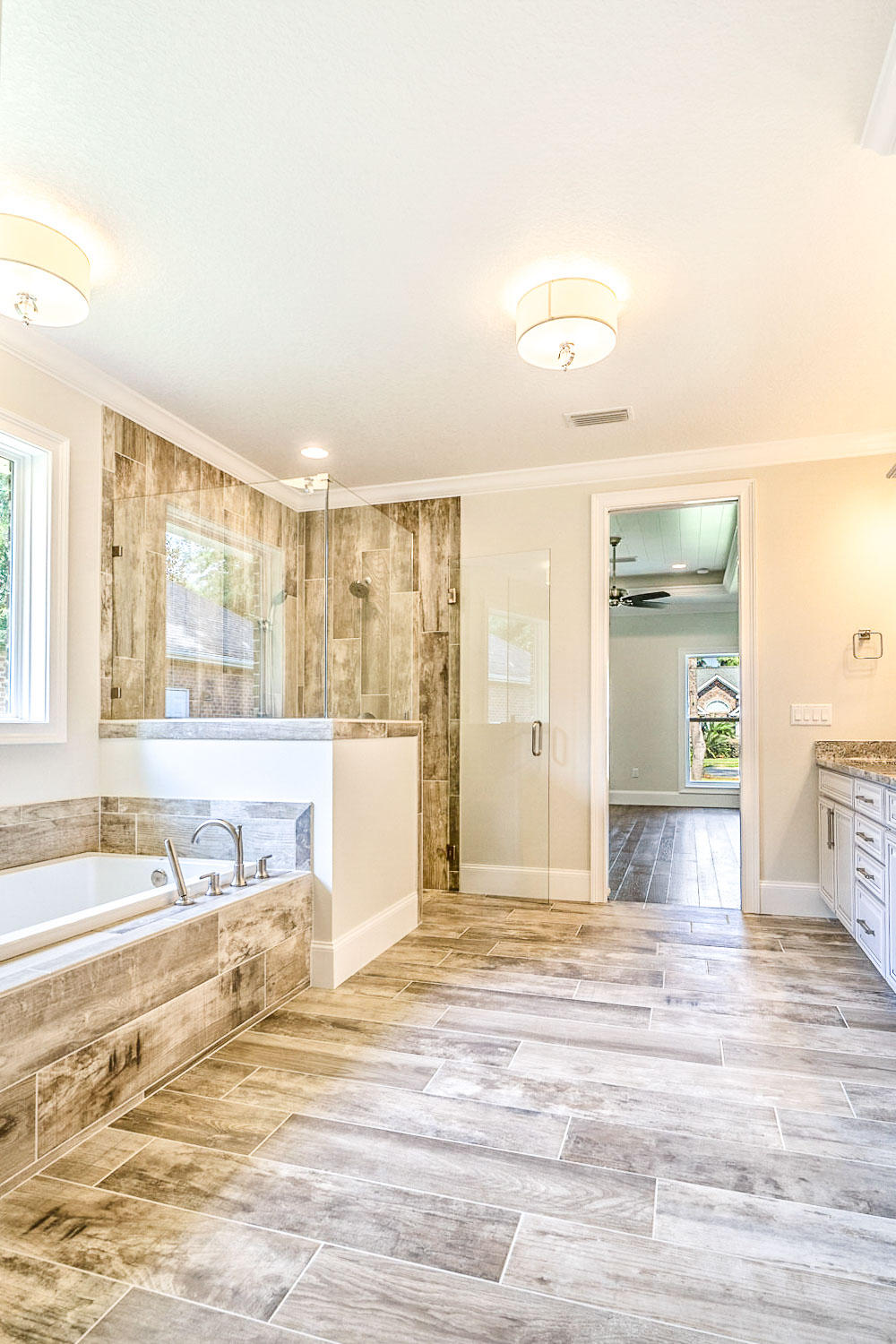 4809 Grove Street Crestview, FL 32539 - Photo 21 of 28 a view of a spacious bathroom with a tub and a large window