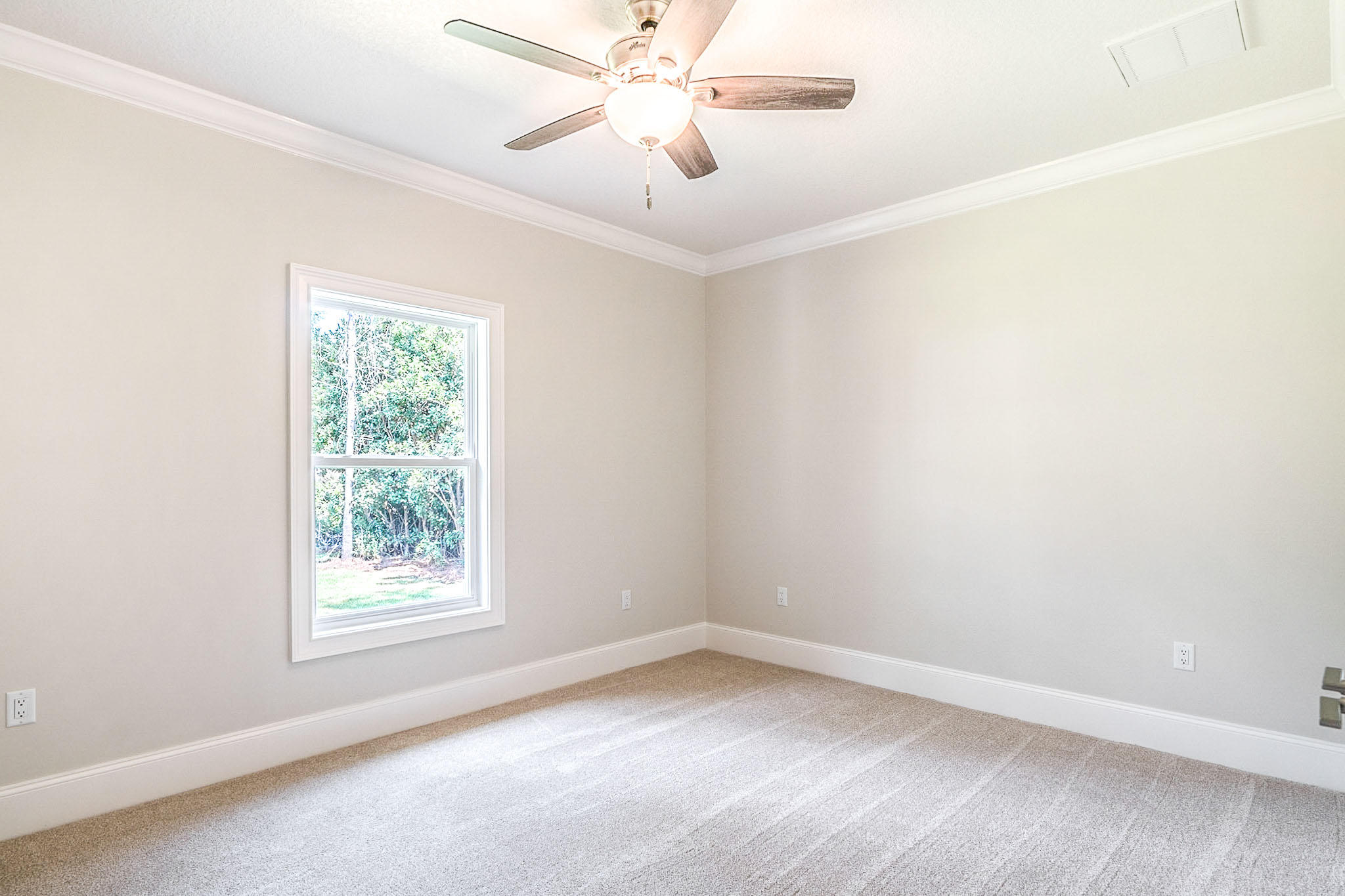 4809 Grove Street Crestview, FL 32539 - Photo 23 of 28 an empty room with a window and a fan