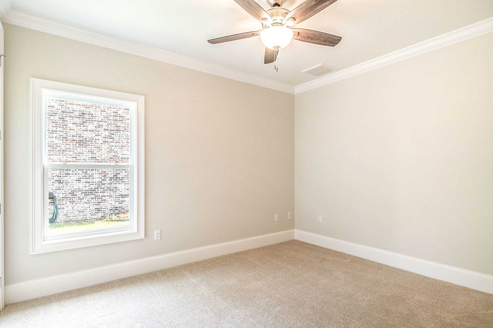 4809 Grove Street Crestview, FL 32539 - Photo 27 of 28 an empty room with a window and a fan