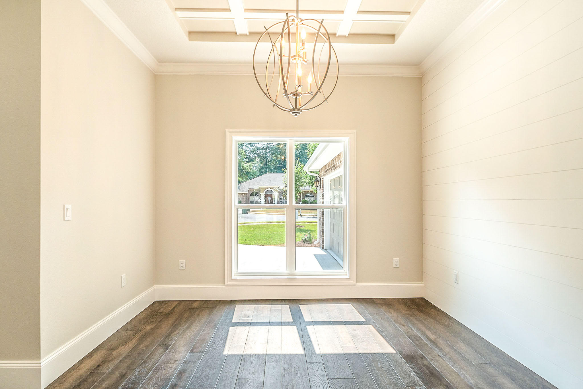 4809 Grove Street Crestview, FL 32539 - Photo 4 of 28 an empty room with wooden floor and windows
