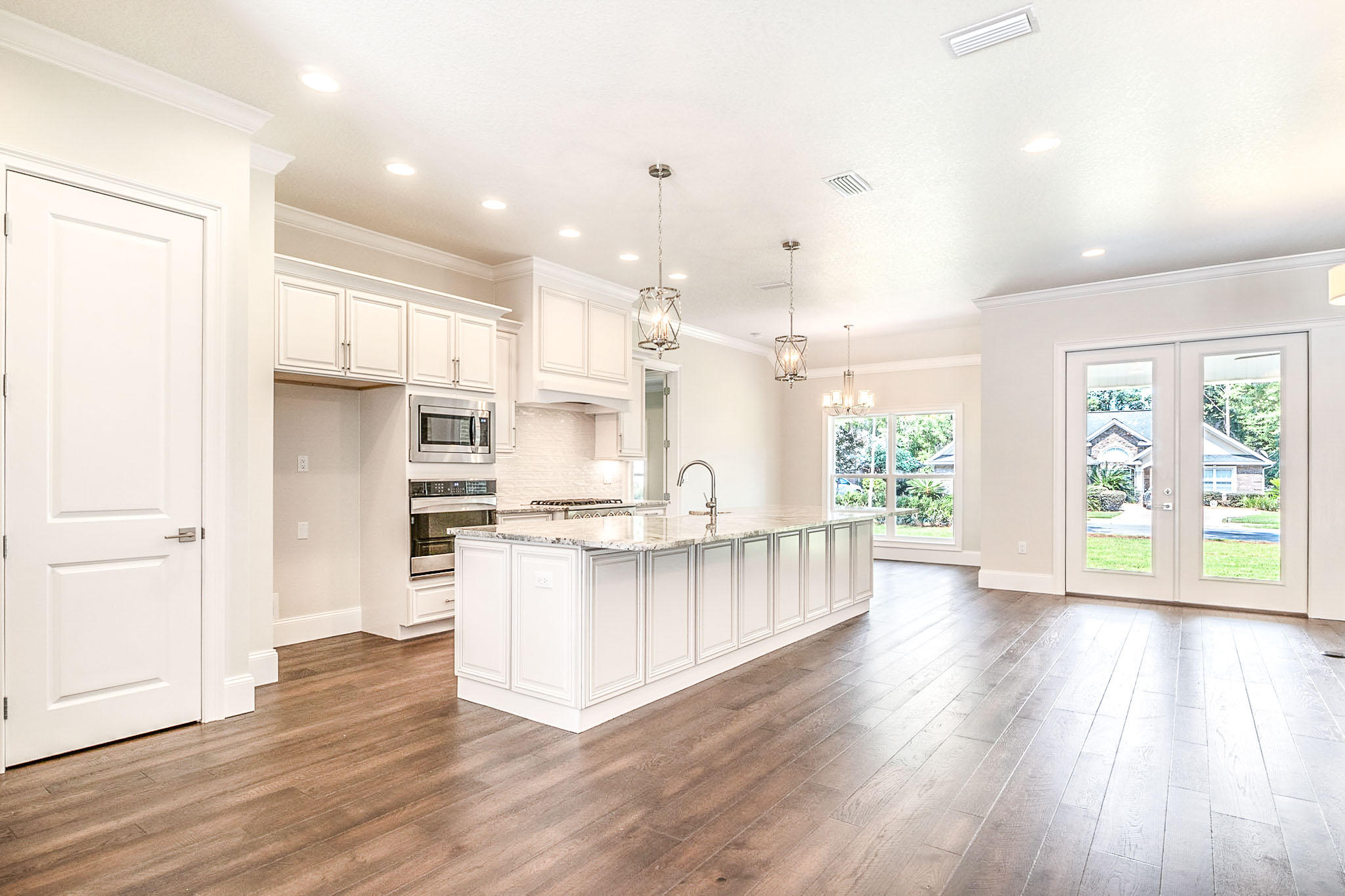 4809 Grove Street Crestview, FL 32539 - Photo 8 of 28 a kitchen with stainless steel appliances a stove top oven and a refrigerator