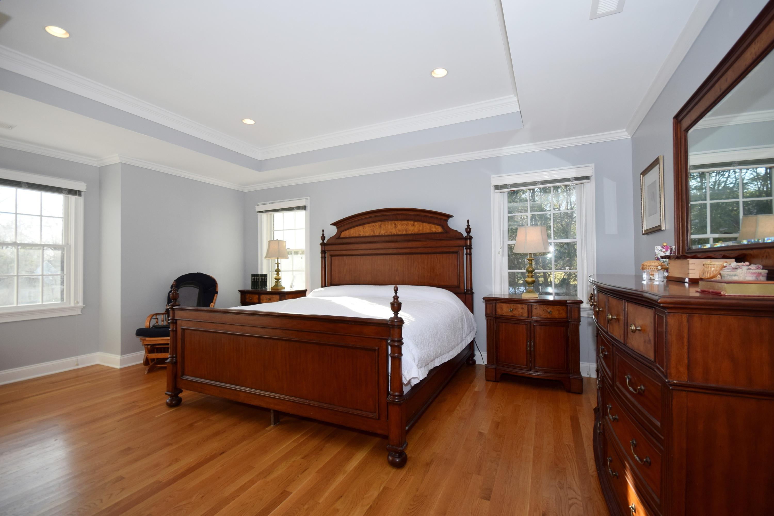 6 Wilson Ridge Road East Darien, CT 06820 - Photo 15 of 25 a bedroom with a bed and a large window with wooden floor
