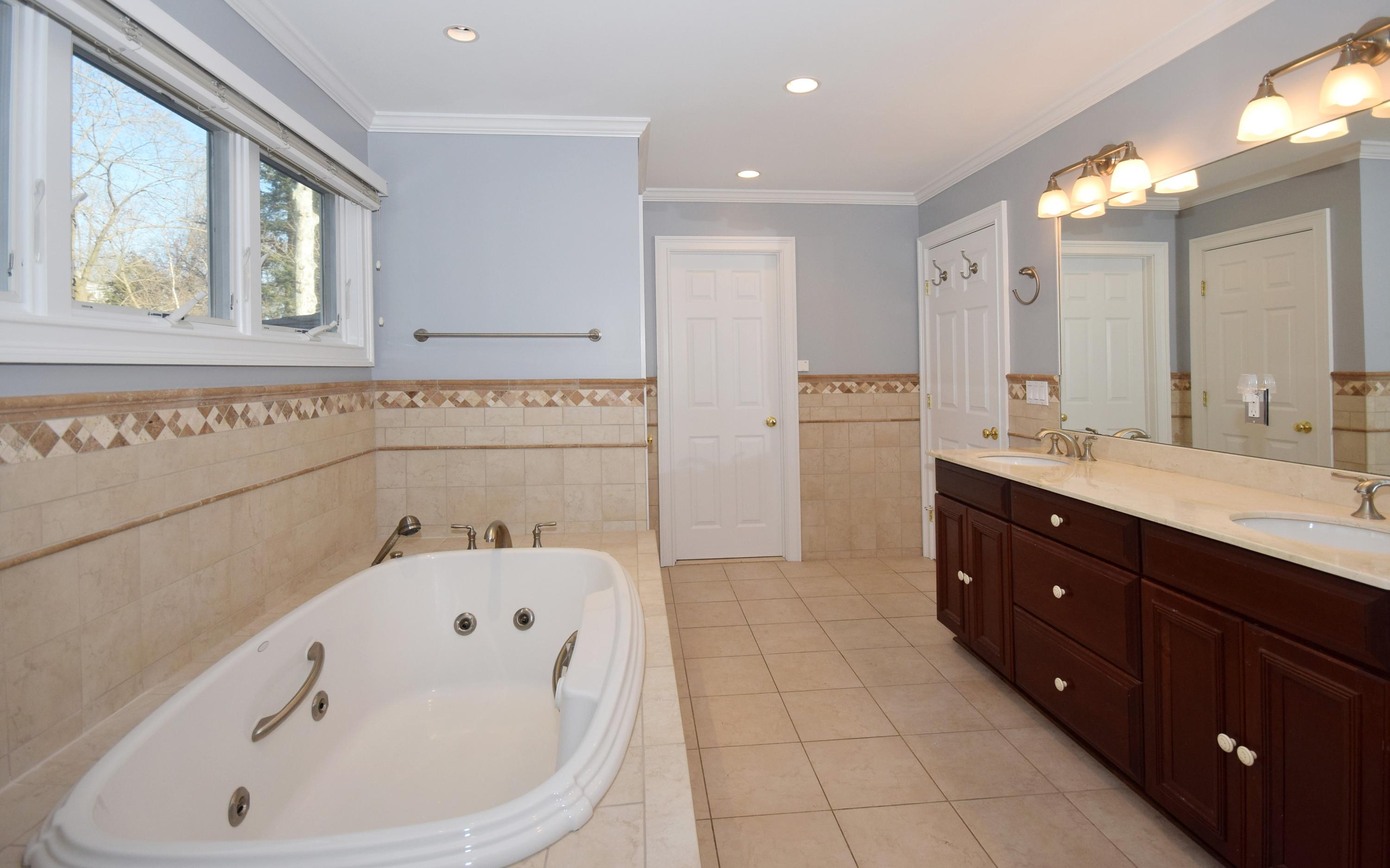 6 Wilson Ridge Road East Darien, CT 06820 - Photo 17 of 25 a bathroom with a bathtub sink and mirror