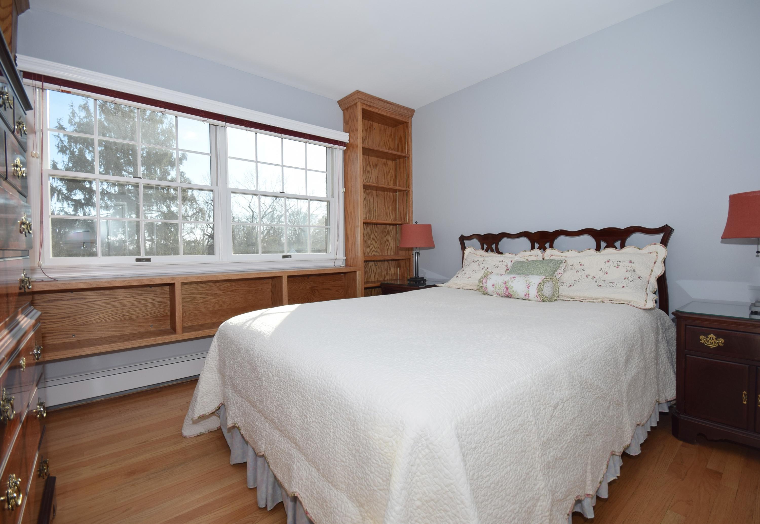 6 Wilson Ridge Road East Darien, CT 06820 - Photo 20 of 25 a bedroom with a large bed and a large window