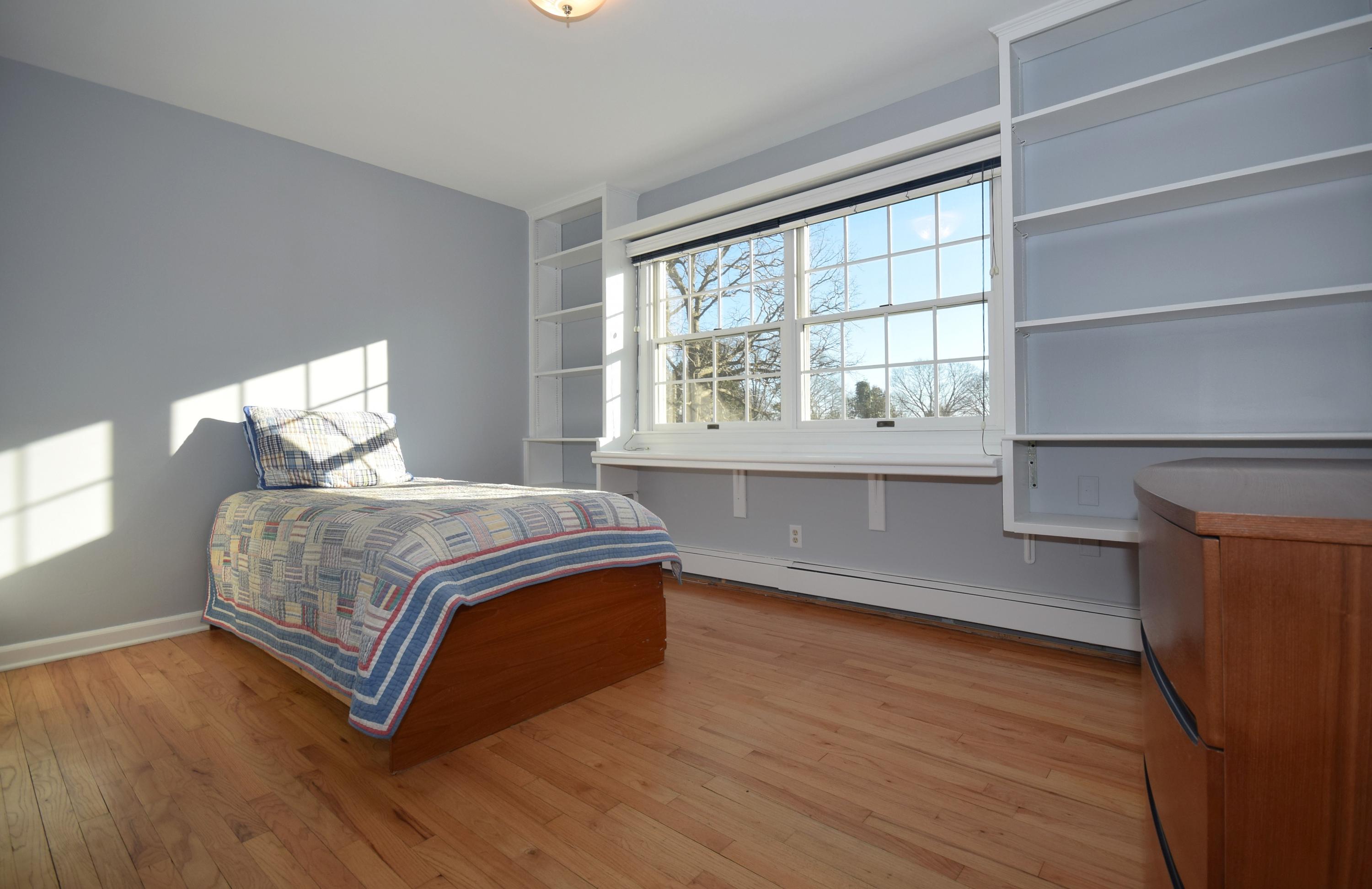 6 Wilson Ridge Road East Darien, CT 06820 - Photo 21 of 25 a bedroom with a bed and a large window