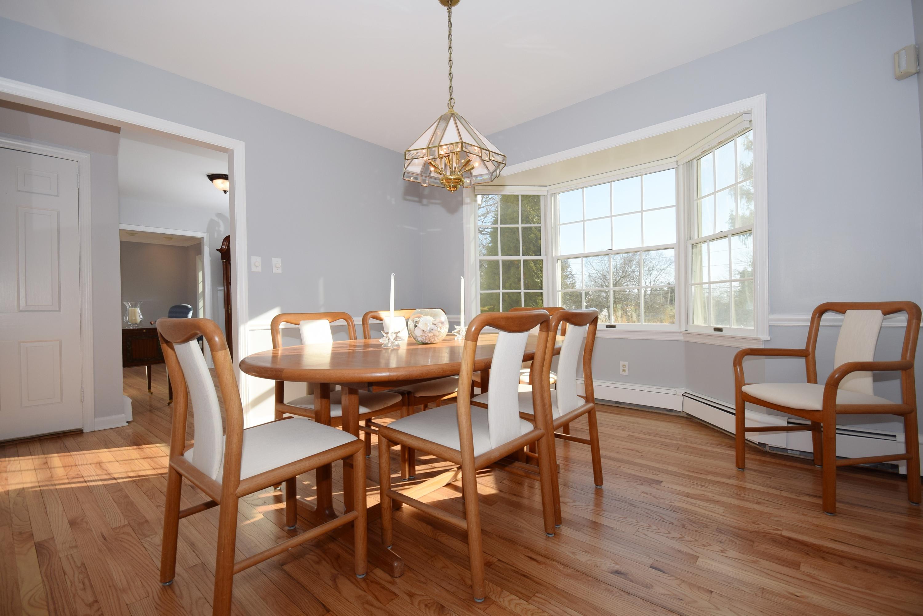 6 Wilson Ridge Road East Darien, CT 06820 - Photo 6 of 25 a view of a dining room with furniture a chandelier and wooden floor