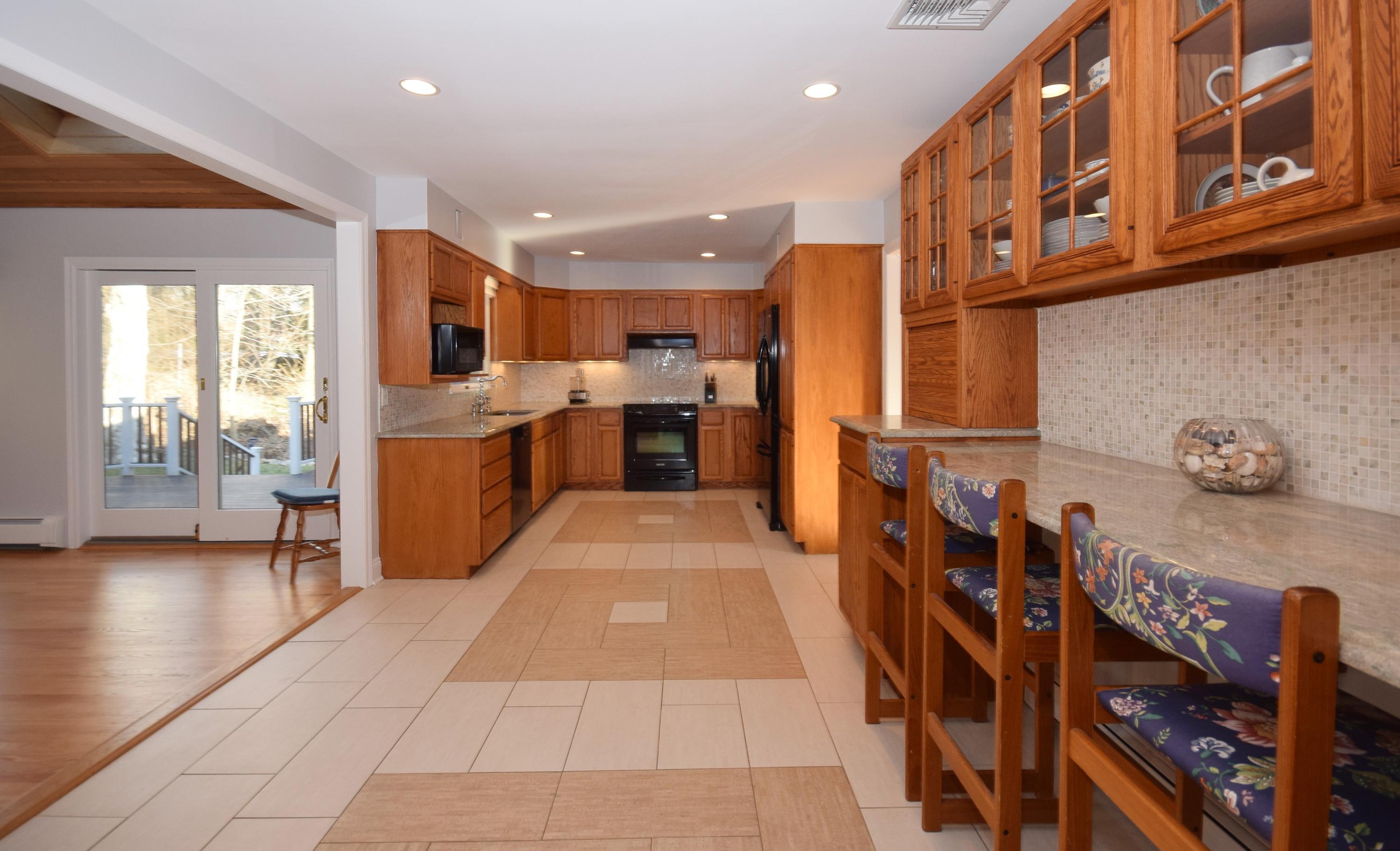 6 Wilson Ridge Road East Darien, CT 06820 - Photo 7 of 25 a open kitchen with stainless steel appliances granite countertop a refrigerator and a stove top oven with wooden floor