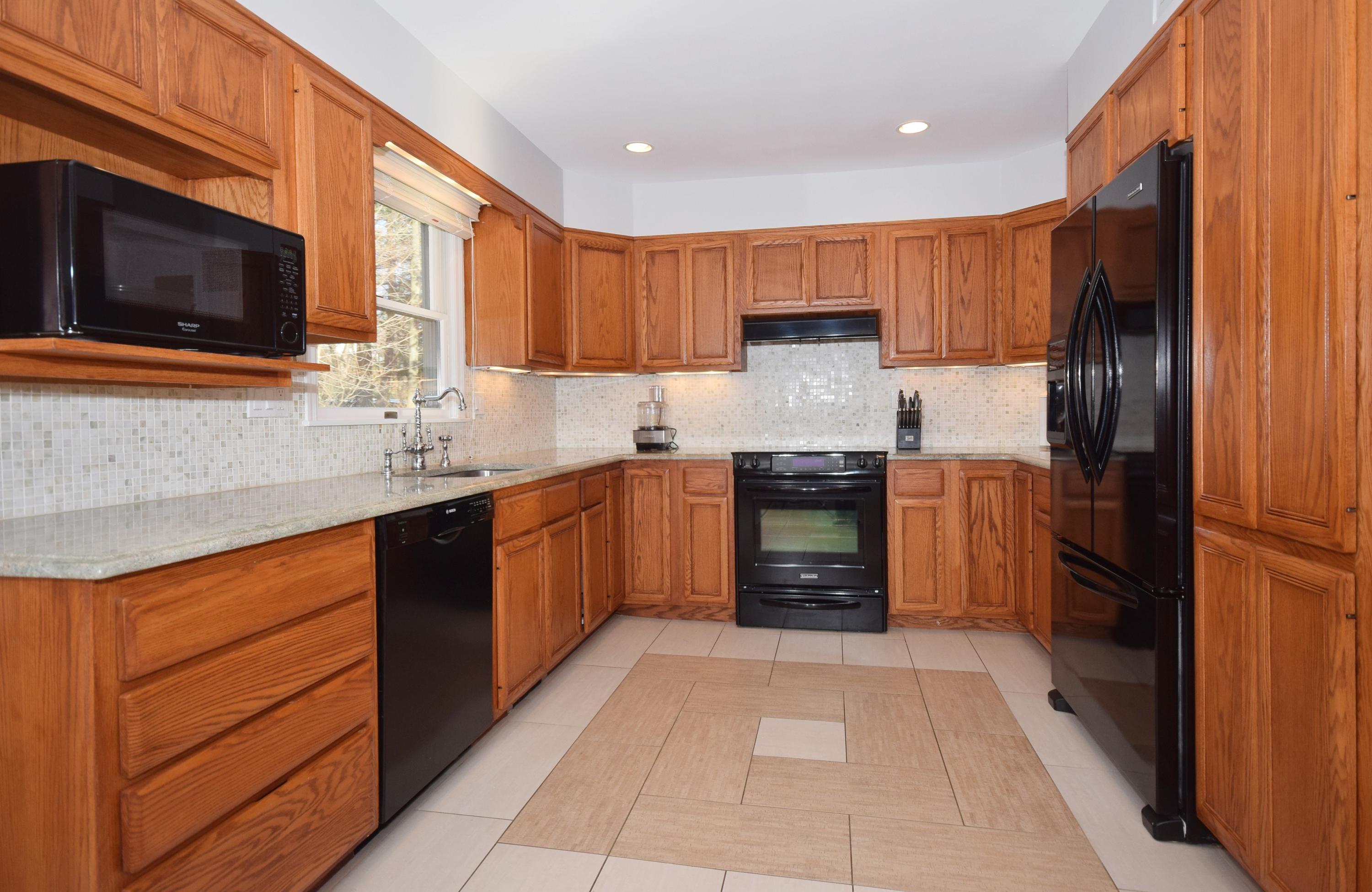 6 Wilson Ridge Road East Darien, CT 06820 - Photo 8 of 25 a kitchen with stainless steel appliances granite countertop a refrigerator and a stove top oven