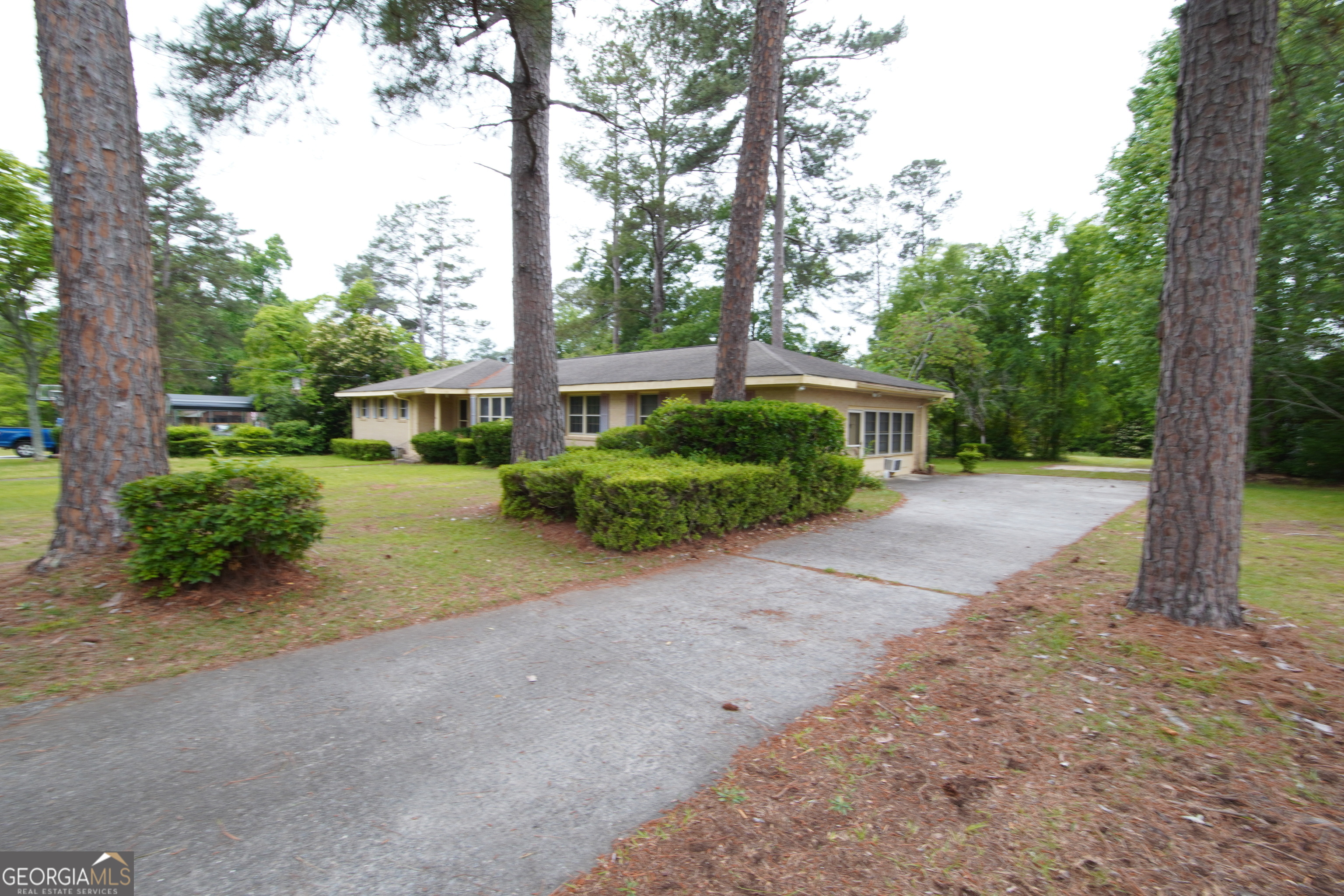 1712 Briarcliff Road Milledgeville, GA 31061 - Photo 3 of 38 a front view of a house with a yard and potted plants