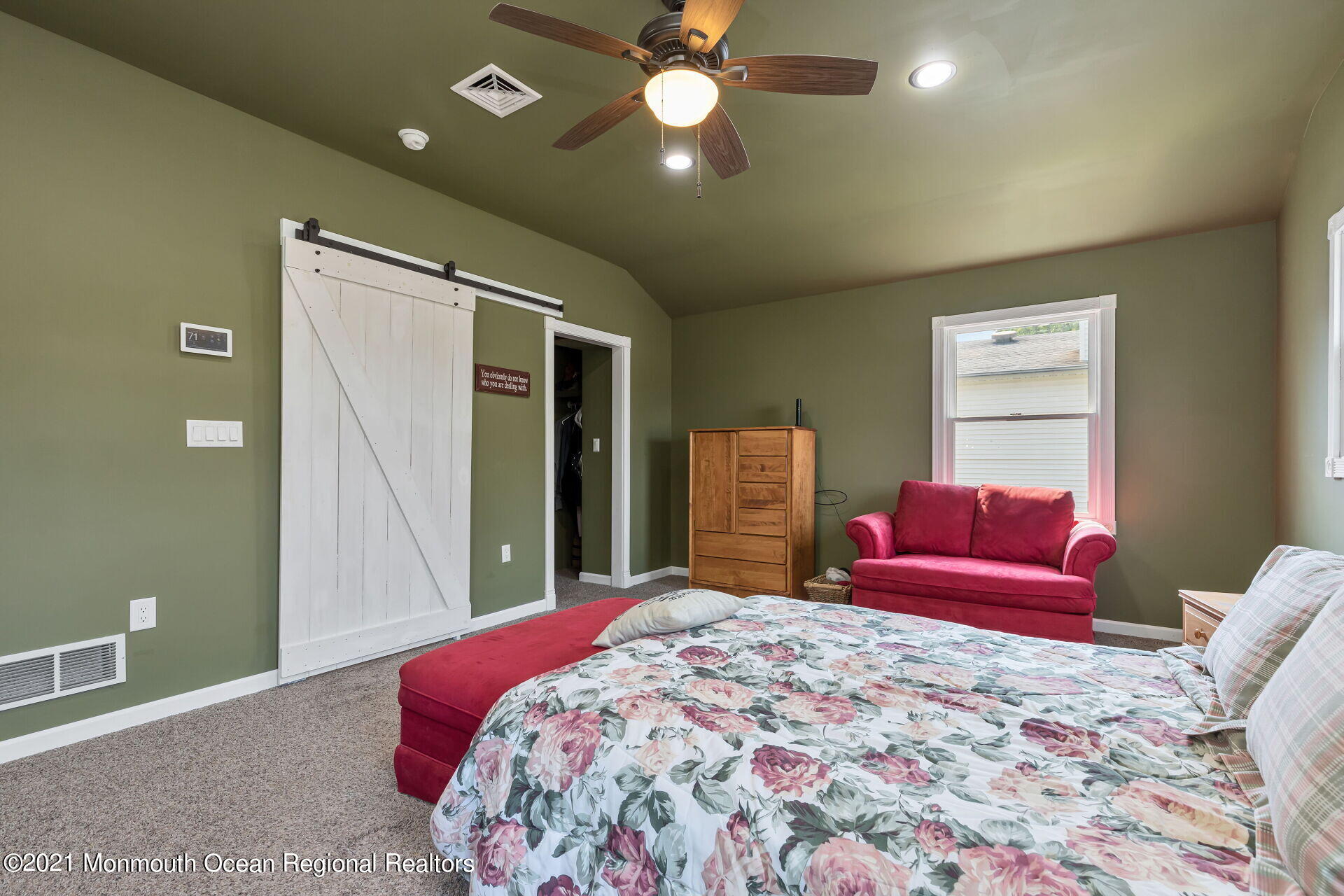 107 Aberdeen Road Aberdeen, NJ 07747 - Photo 25 of 32 a bedroom with a large bed and a chandelier