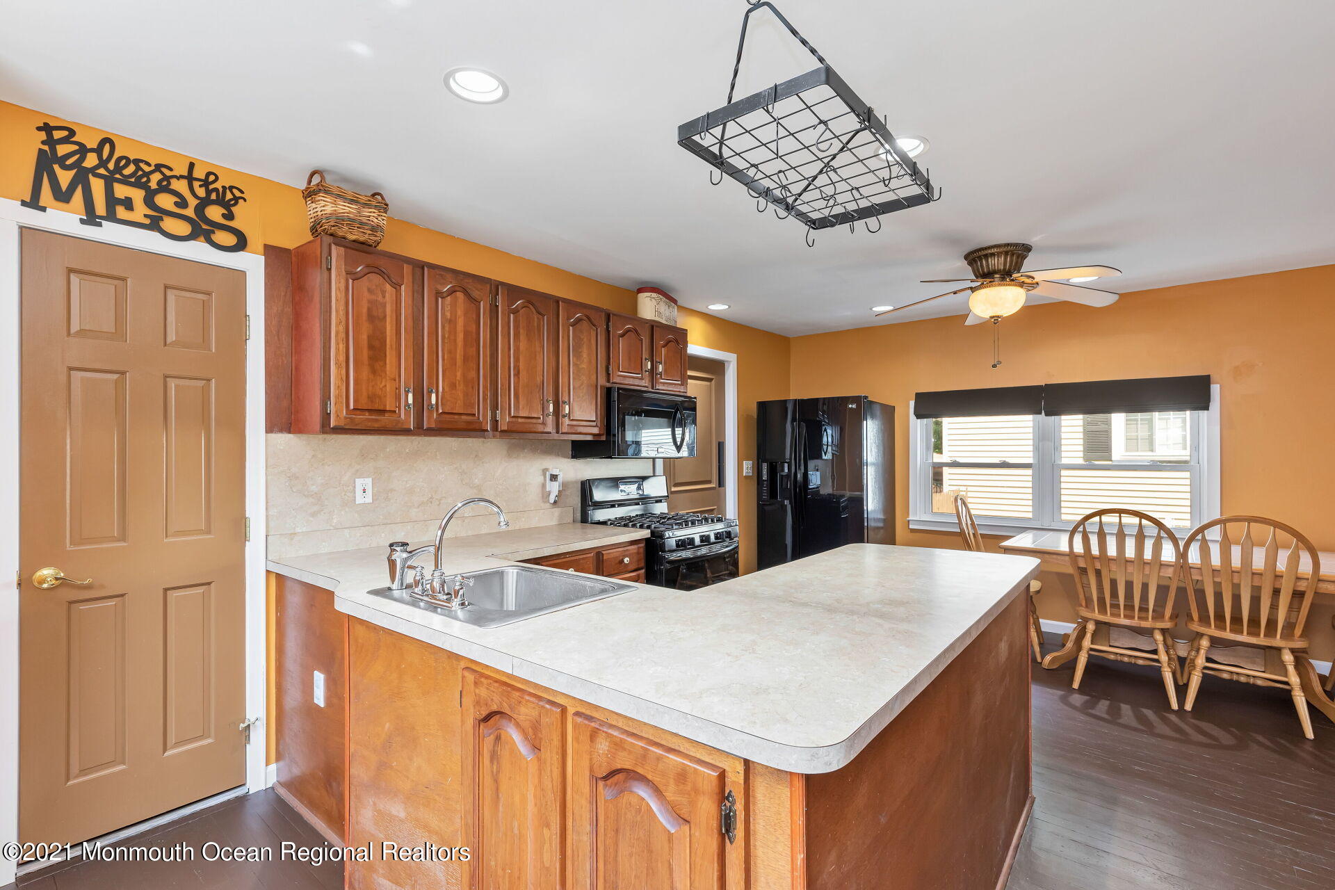 107 Aberdeen Road Aberdeen, NJ 07747 - Photo 9 of 32 a kitchen with stainless steel appliances granite countertop a sink dishwasher a dining table and chairs with wooden floor