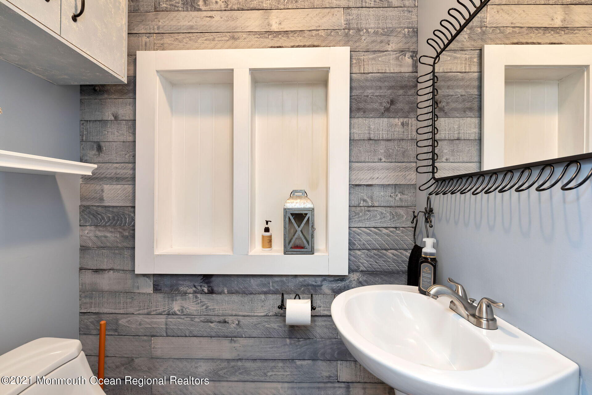 107 Aberdeen Road Aberdeen, NJ 07747 - Photo 10 of 32 a bathroom with a sink and a mirror