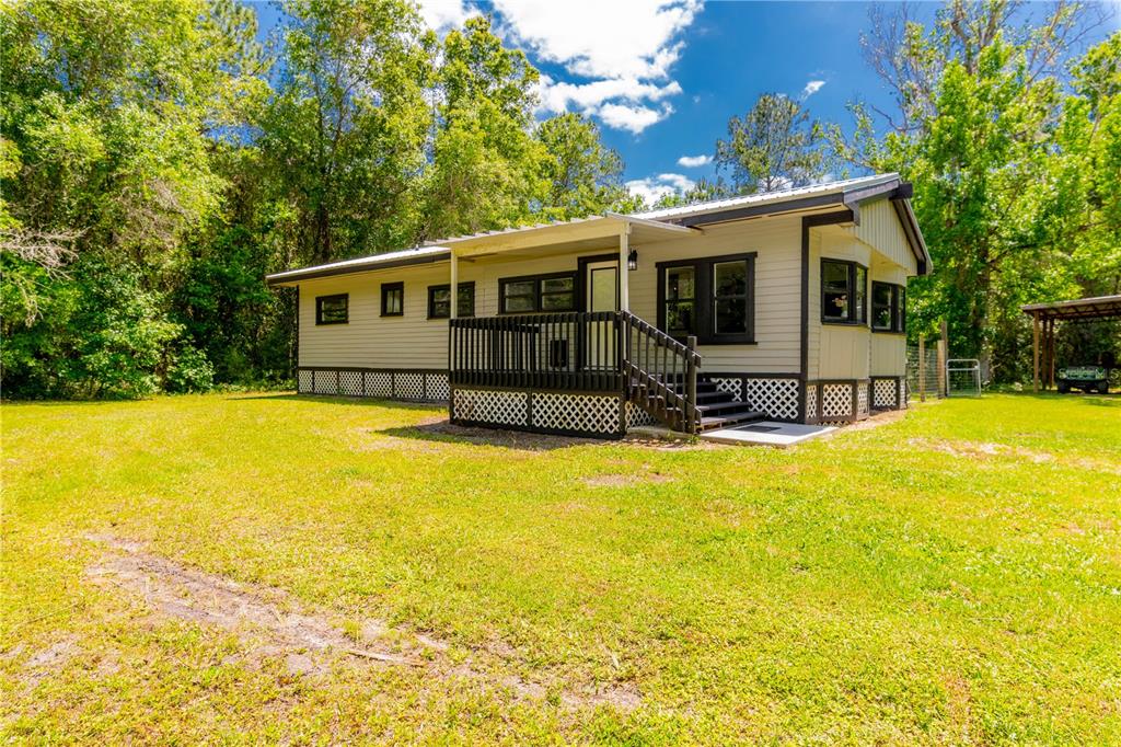 4150 Racers Way Brooksville, FL 34604 - Photo 1 of 1 a front view of house with swimming pool