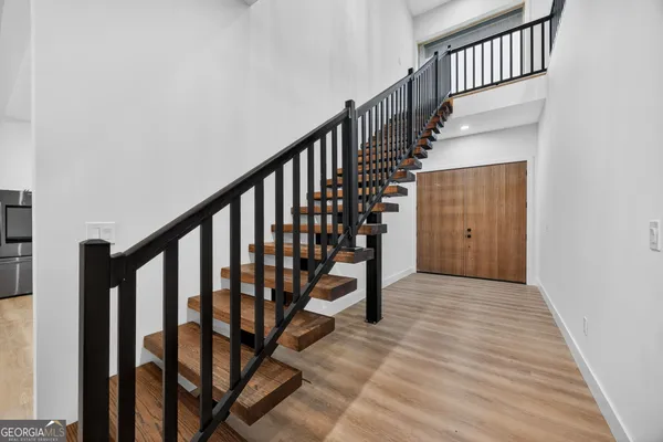 a view of staircase with wooden floor and a window