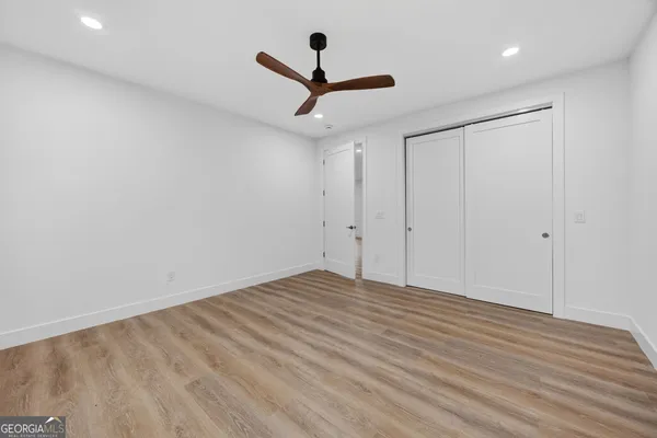 a view of empty room with wooden floor
