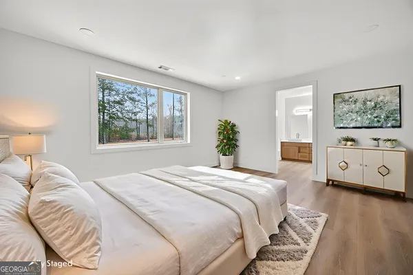 a bedroom with a large bed and a window