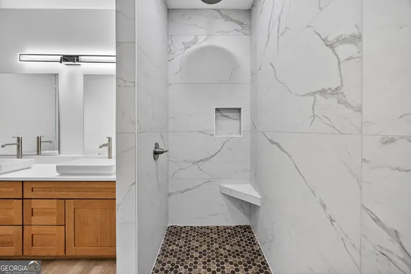 a bathroom with a sink and mirror