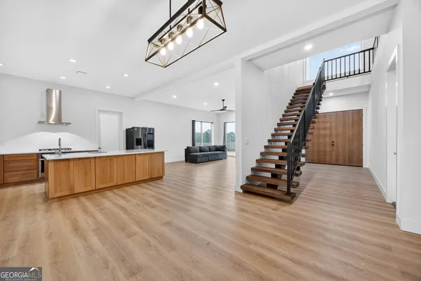 a view of kitchen with sink and wooden floor