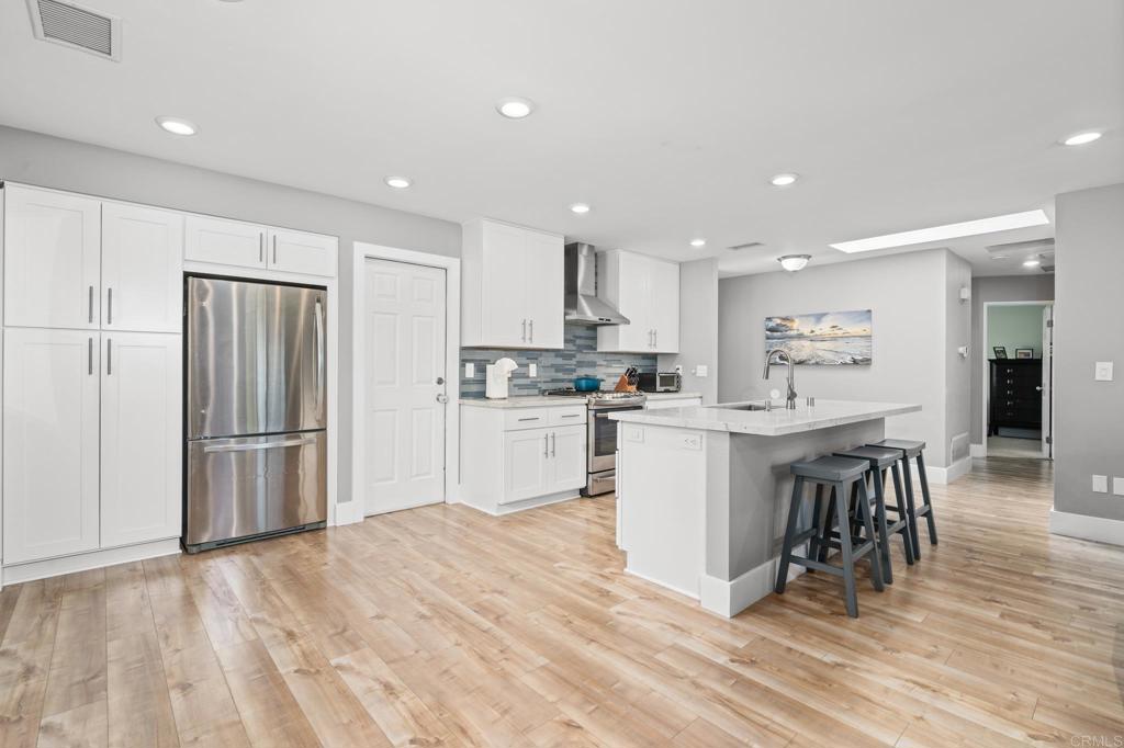 13439 Orange Blossom Lane Poway, CA 92064 - Photo 1 of 36 a kitchen with a refrigerator and a table
