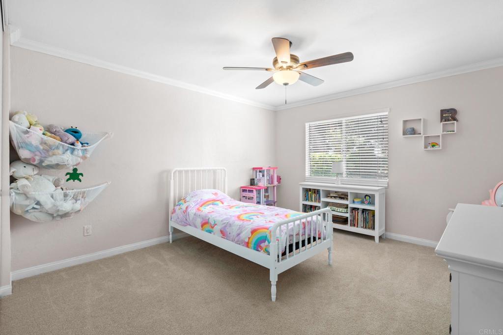 13439 Orange Blossom Lane Poway, CA 92064 - Photo 14 of 36 a bedroom with a bed and a chandelier