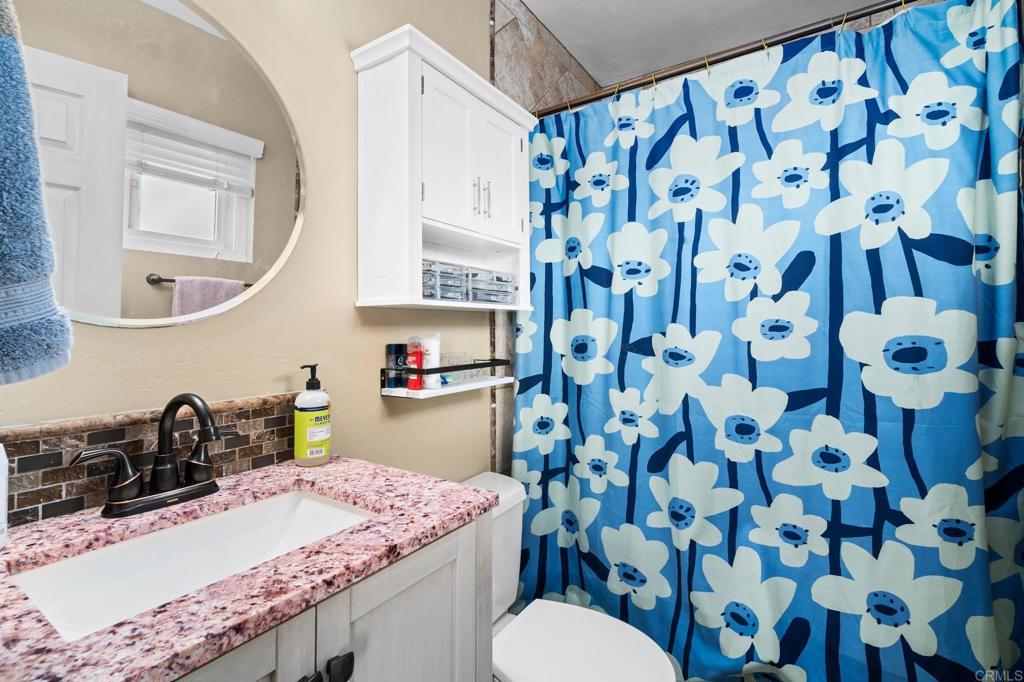 13439 Orange Blossom Lane Poway, CA 92064 - Photo 17 of 36 a bathroom with a sink toilet and shower