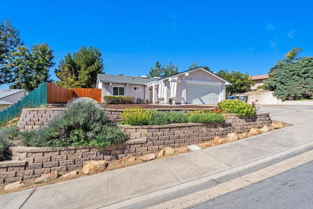13439 Orange Blossom Lane Poway, CA 92064 - Photo 25 of 36 a front view of a house with a garden and mountain view