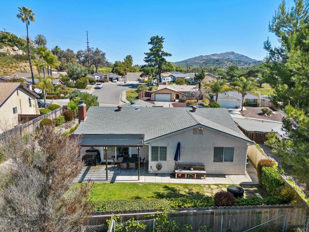13439 Orange Blossom Lane Poway, CA 92064 - Photo 27 of 36 a aerial view of a house with swimming pool and a yard