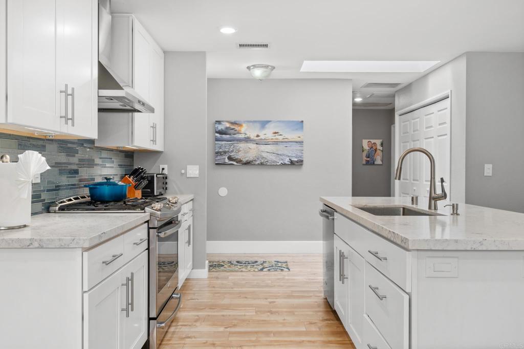 13439 Orange Blossom Lane Poway, CA 92064 - Photo 3 of 36 a kitchen with stainless steel appliances granite countertop a sink stove and cabinets