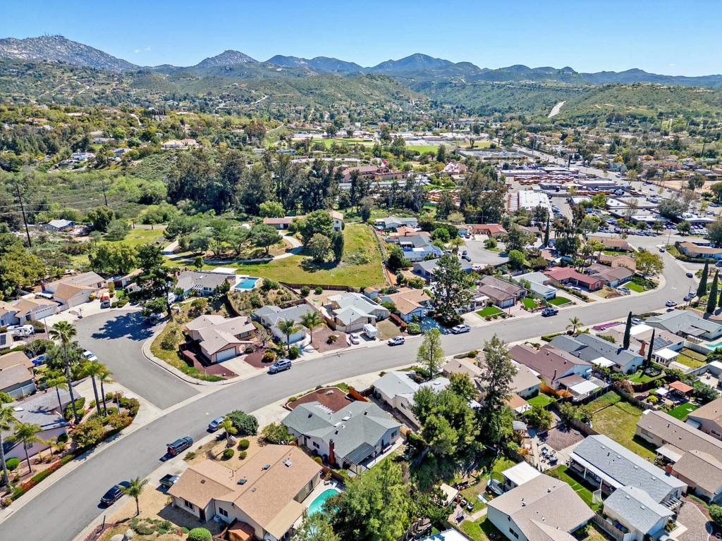 13439 Orange Blossom Lane Poway, CA 92064 - Photo 32 of 36 an aerial view of a city with lots of residential buildings and mountain view in back