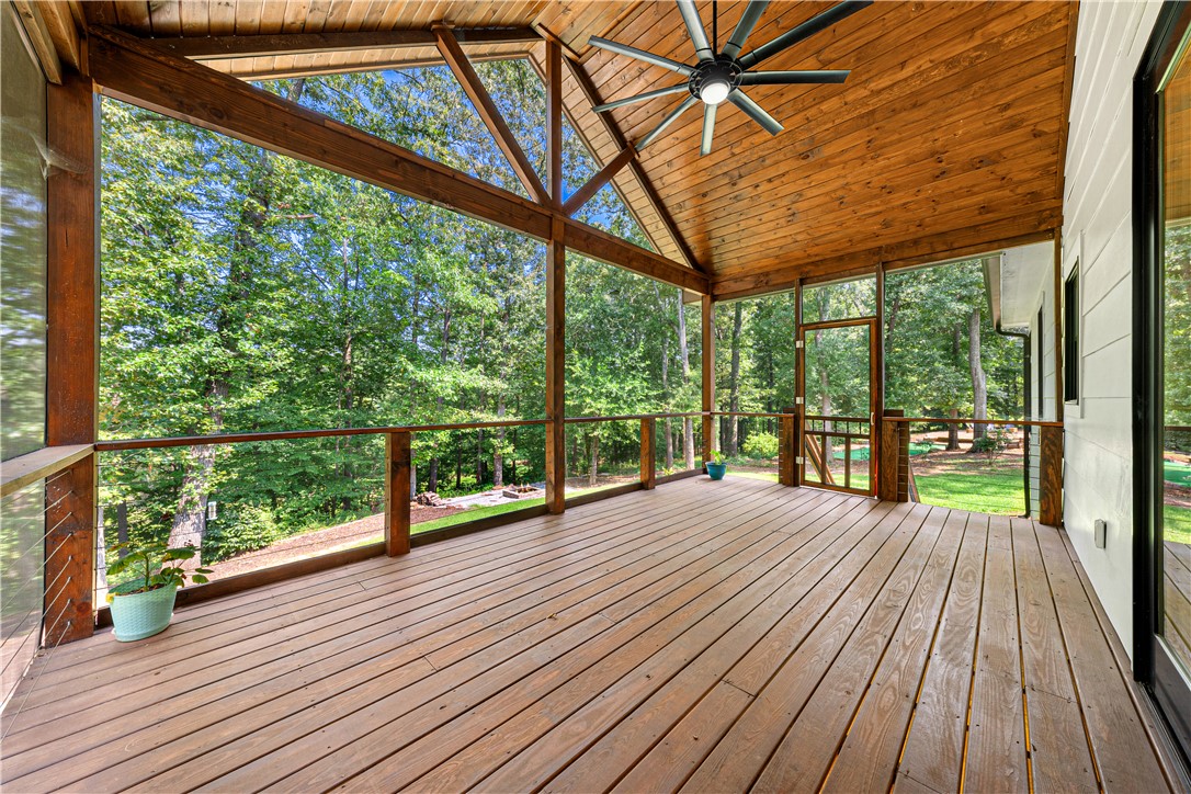 516 Winding Way Hartwell, GA 30643 - Photo 22 of 50 An inviting screened porch overlooks a tranquil, tree-filled natural setting, perfect for relaxed outdoor living.
