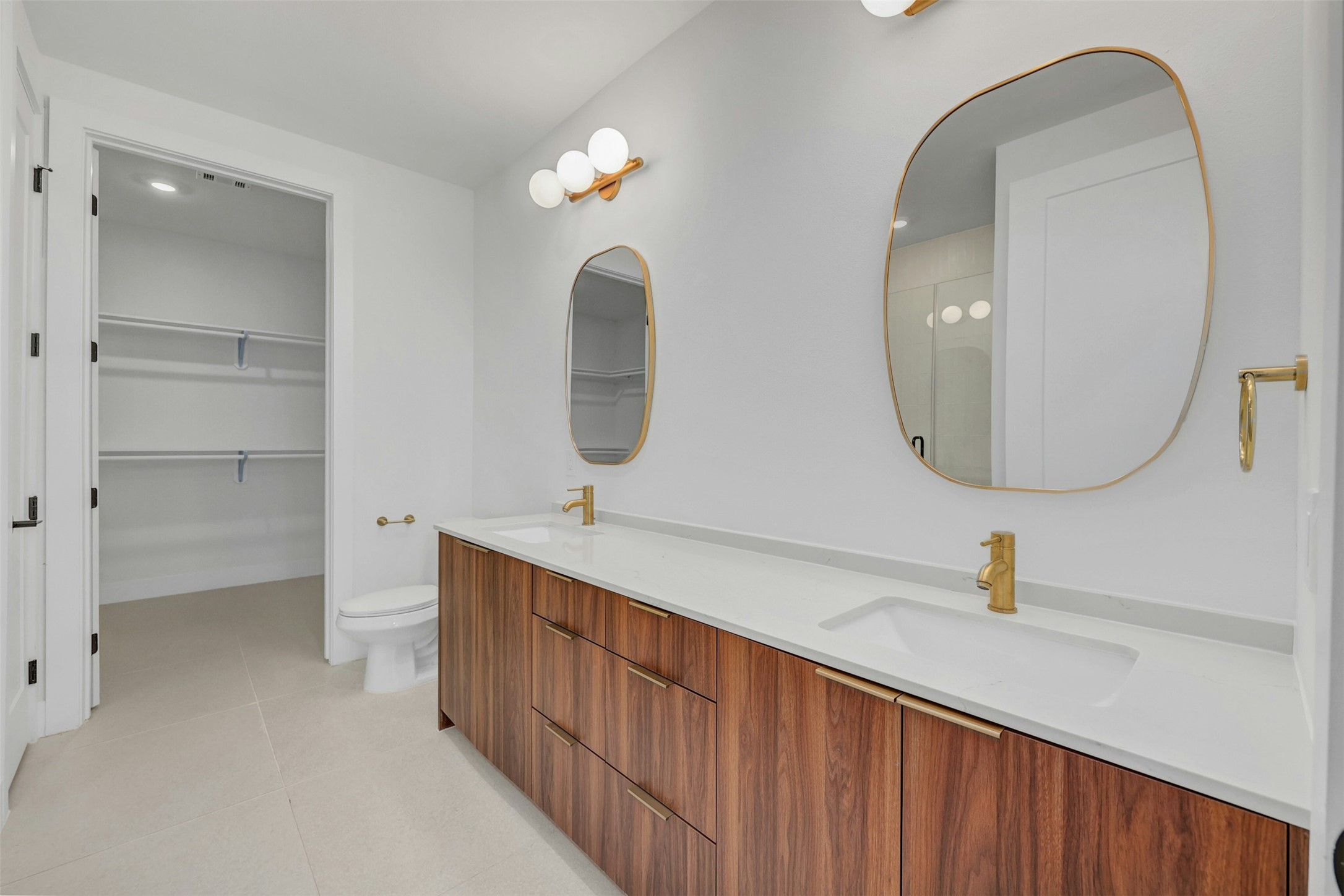 1701 Simond Avenue, Unit 411 Austin, TX 78723 - Photo 13 of 34 Full bath with double vanity, tile patterned floors, and a spacious closet