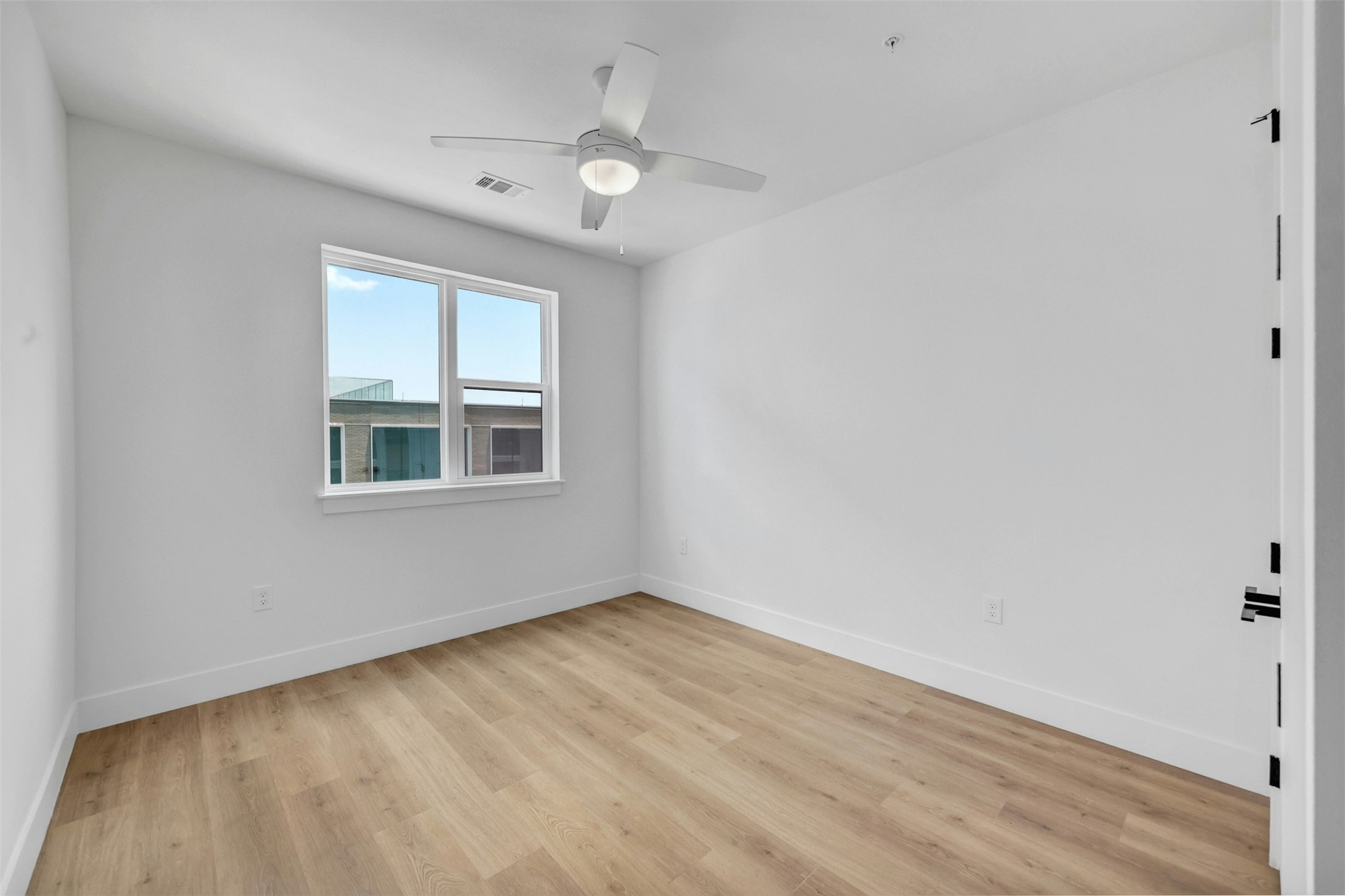 1701 Simond Avenue, Unit 411 Austin, TX 78723 - Photo 16 of 34 Spare room with a ceiling fan and light wood finished floors