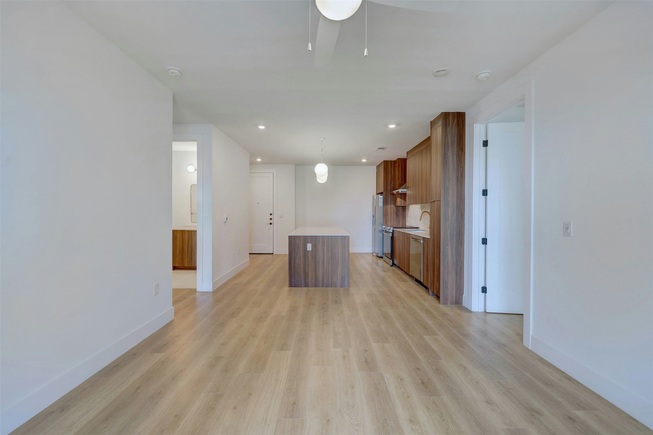 1701 Simond Avenue, Unit 411 Austin, TX 78723 - Photo 8 of 34 Unfurnished living room featuring light wood-style flooring, ceiling fan, and recessed lighting