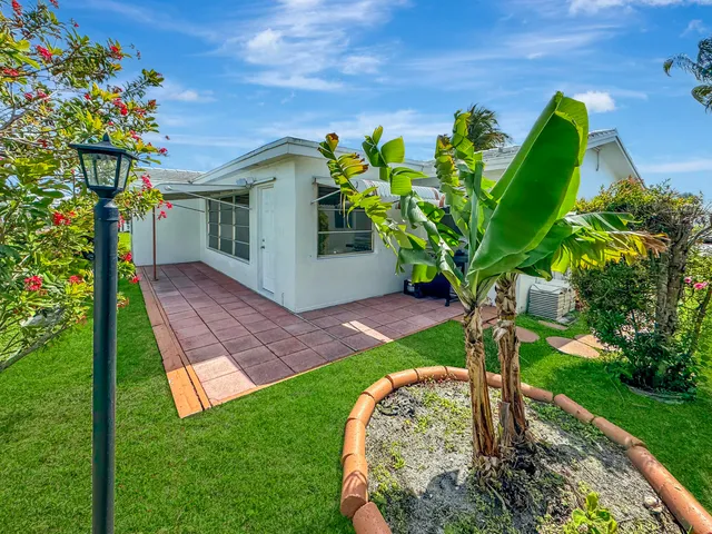 a large kitchen with stainless steel appliances granite countertop a refrigerator and a sink