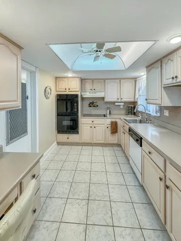 a living room with furniture a table and a potted plant