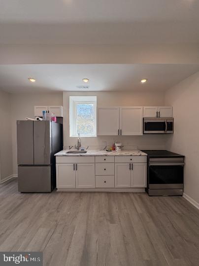 3625 North 22nd Street, Unit 1 Philadelphia, PA 19140 - Photo 1 of 9 a kitchen with cabinets and wooden floor