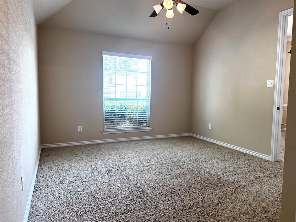 12135 Jasmine Lane Frisco, TX 75035 - Photo 20 of 31 an empty room with a chandelier fan and windows
