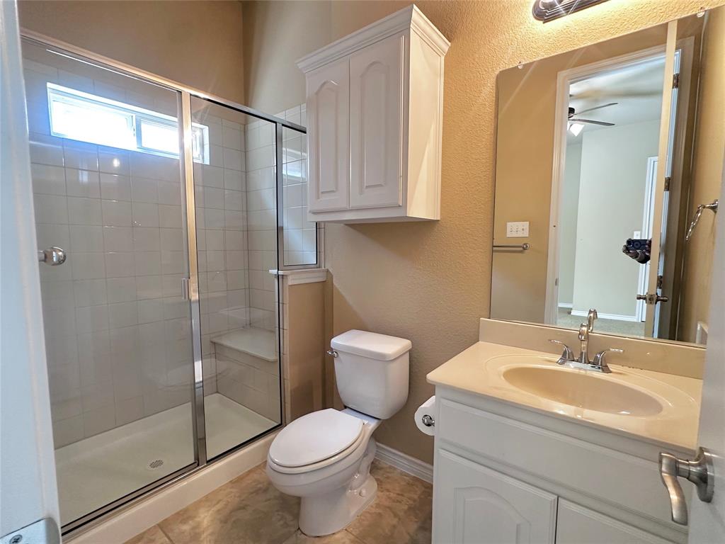 12135 Jasmine Lane Frisco, TX 75035 - Photo 24 of 31 a bathroom with a toilet sink and shower