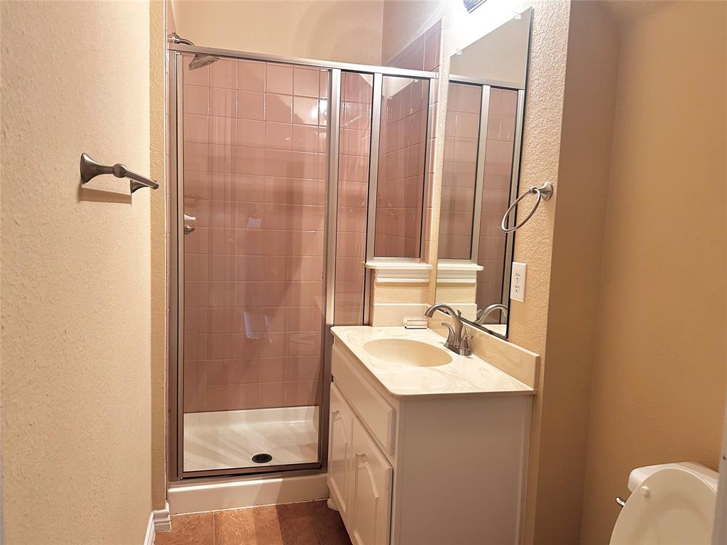 12135 Jasmine Lane Frisco, TX 75035 - Photo 25 of 31 a bathroom with a sink a mirror and a shower