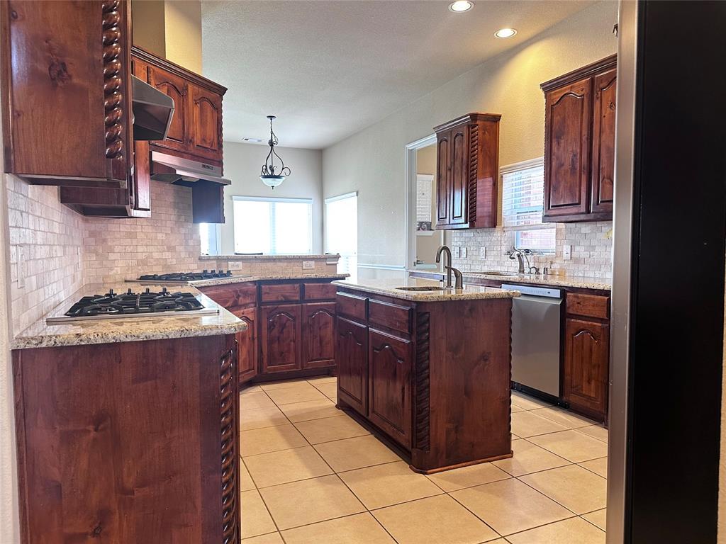 12135 Jasmine Lane Frisco, TX 75035 - Photo 4 of 31 a kitchen with a sink a stove and cabinets