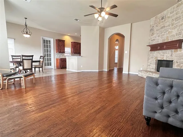 a view of a livingroom with furniture wooden floor a fireplace