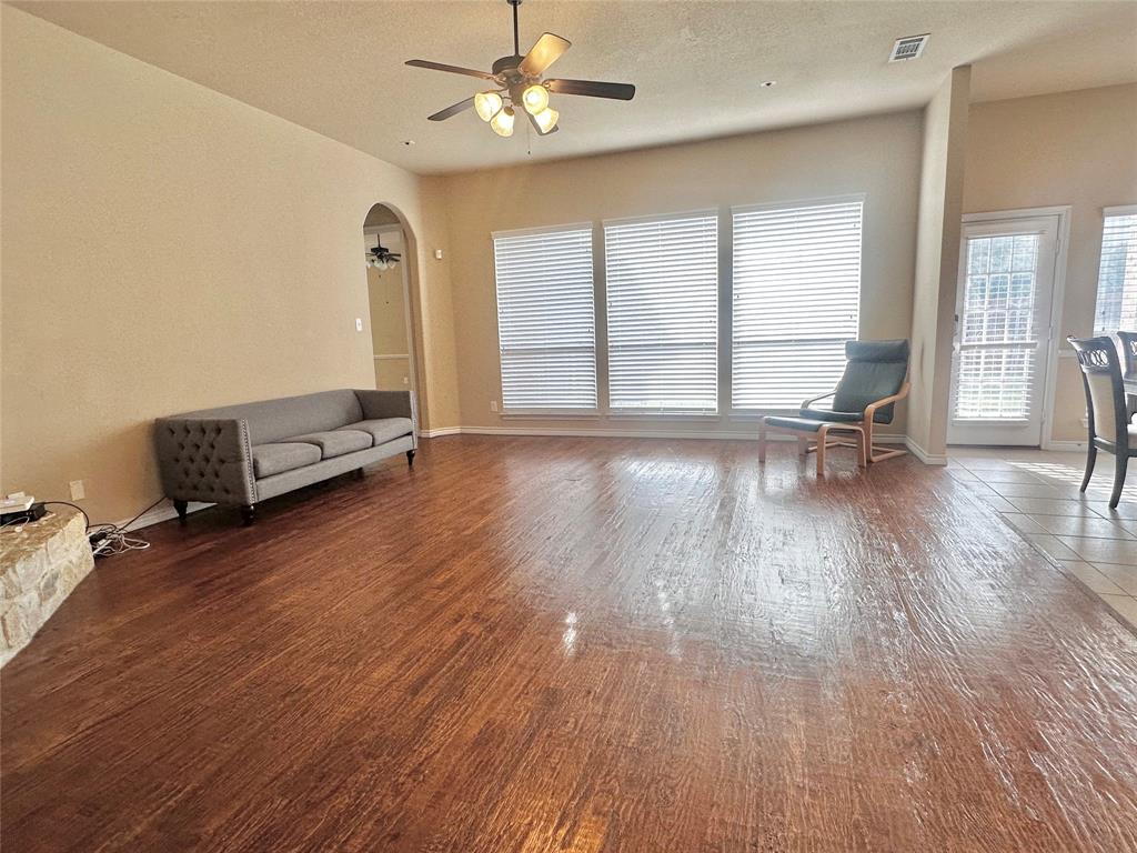 12135 Jasmine Lane Frisco, TX 75035 - Photo 8 of 31 a view of a room with wooden floor and a ceiling fan