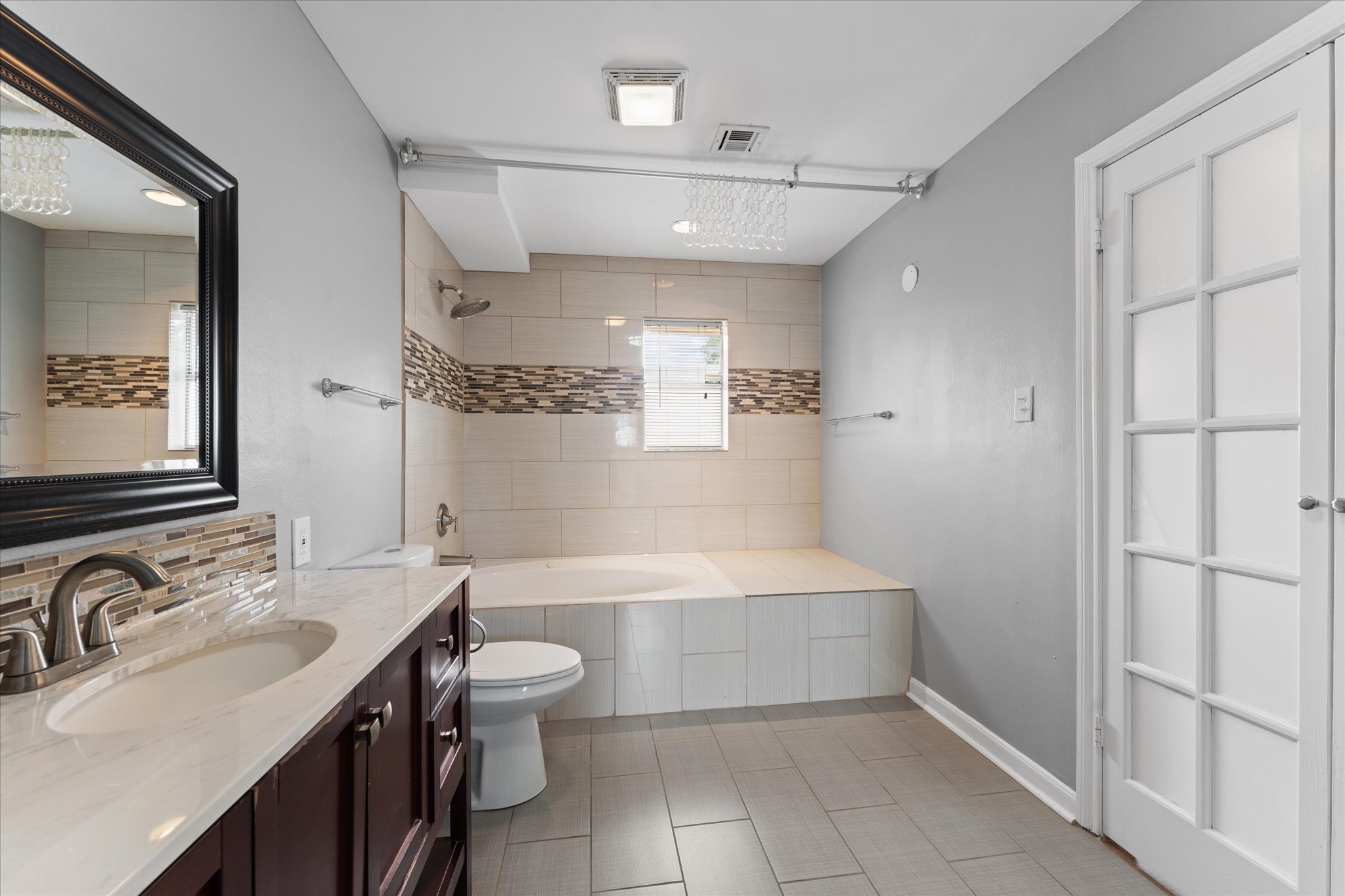 954 Chamboard Lane Houston, TX 77018 - Photo 11 of 36 a bathroom with a sink a toilet and shower