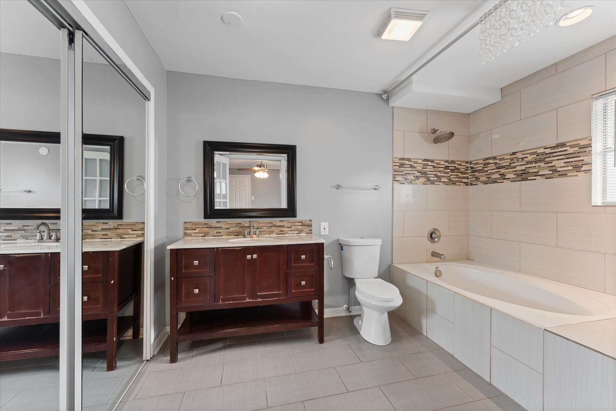 954 Chamboard Lane Houston, TX 77018 - Photo 12 of 36 a spacious bathroom with a toilet sink and mirror