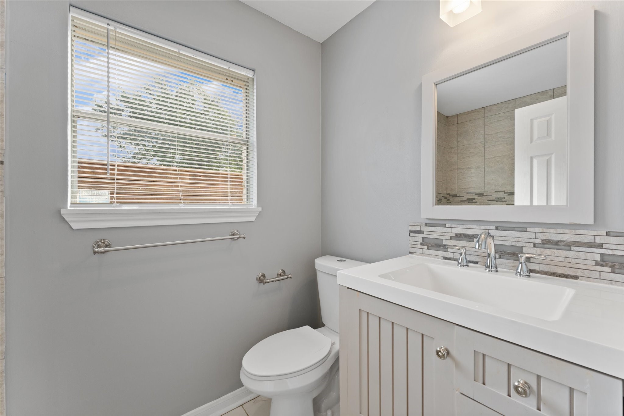 954 Chamboard Lane Houston, TX 77018 - Photo 15 of 36 a bathroom with a sink a toilet and a mirror