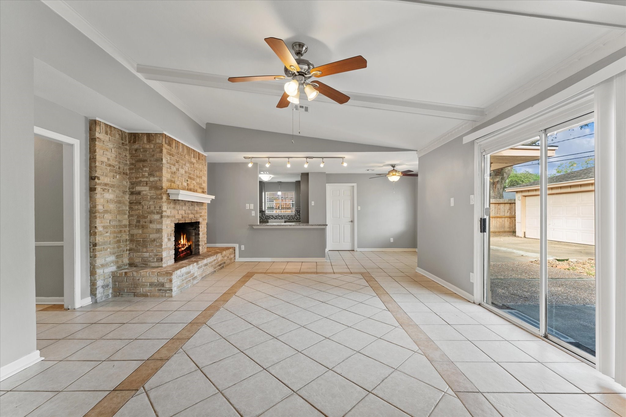 954 Chamboard Lane Houston, TX 77018 - Photo 20 of 36 a view of an empty room with a fireplace and a chandelier fan