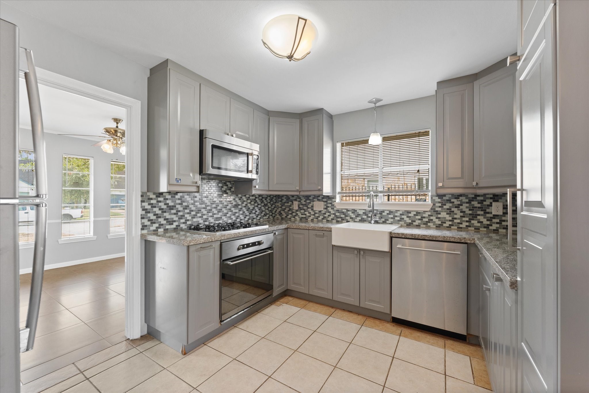954 Chamboard Lane Houston, TX 77018 - Photo 28 of 36 a kitchen with stainless steel appliances granite countertop a stove sink and cabinets