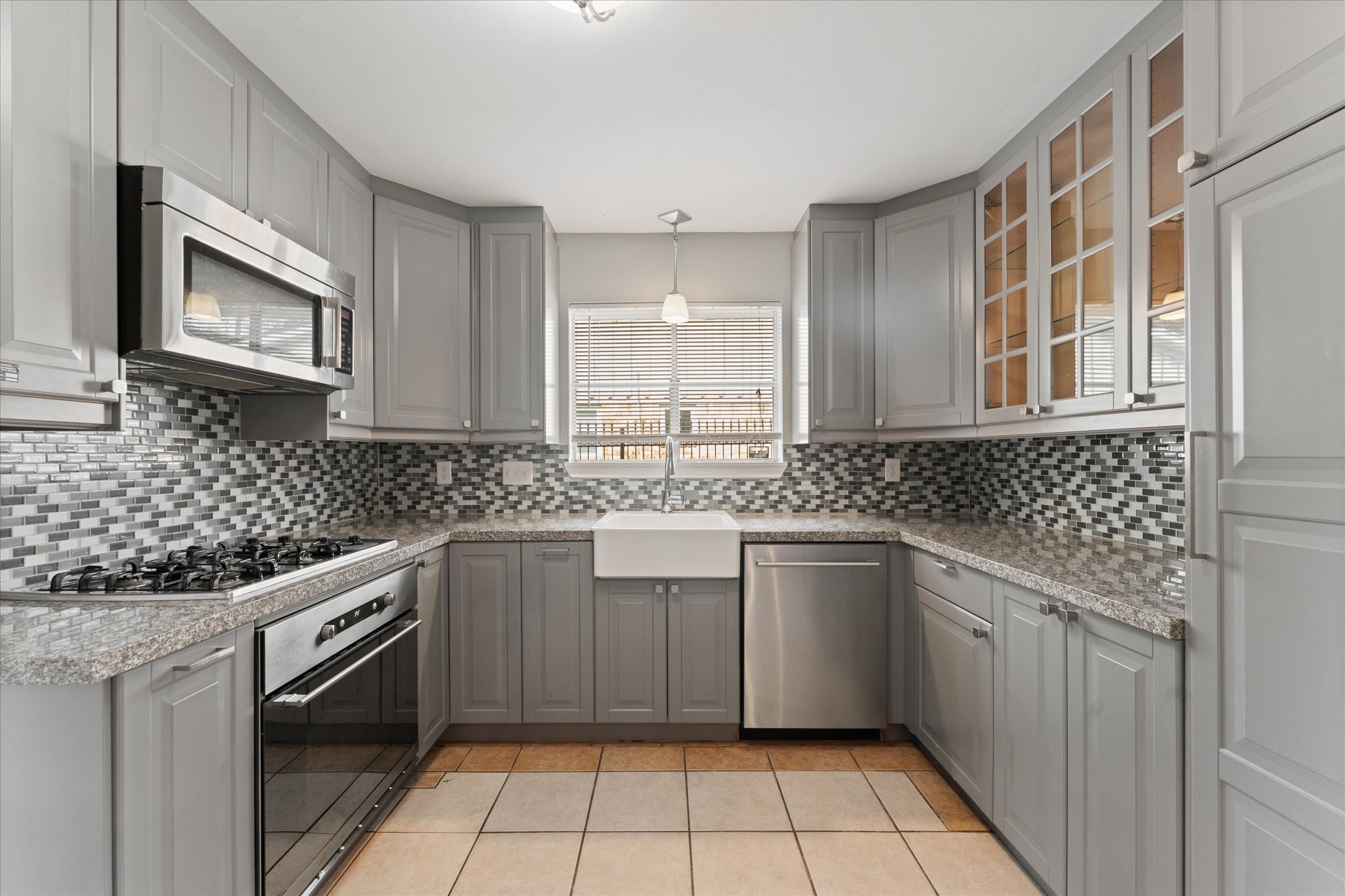 954 Chamboard Lane Houston, TX 77018 - Photo 29 of 36 a kitchen with stainless steel appliances granite countertop a sink stove and microwave
