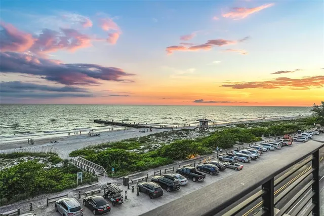 a balcony with wooden floor and outdoor seating